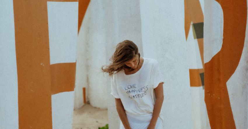 Shore Excursions - A Woman in White Clothing Standing on a Beach